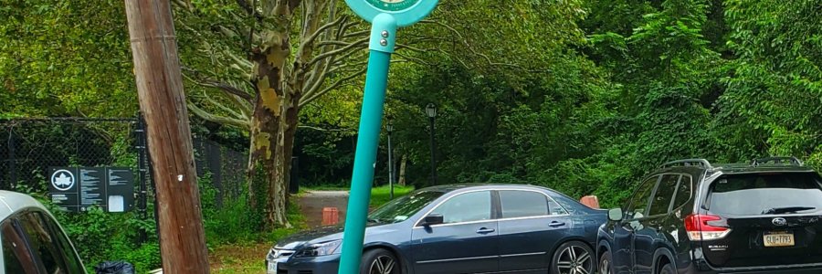 Two cars blocking the greenway since their owners (playing soccer) didn't feel like using the available legal parking spaces a few dozen feet away.