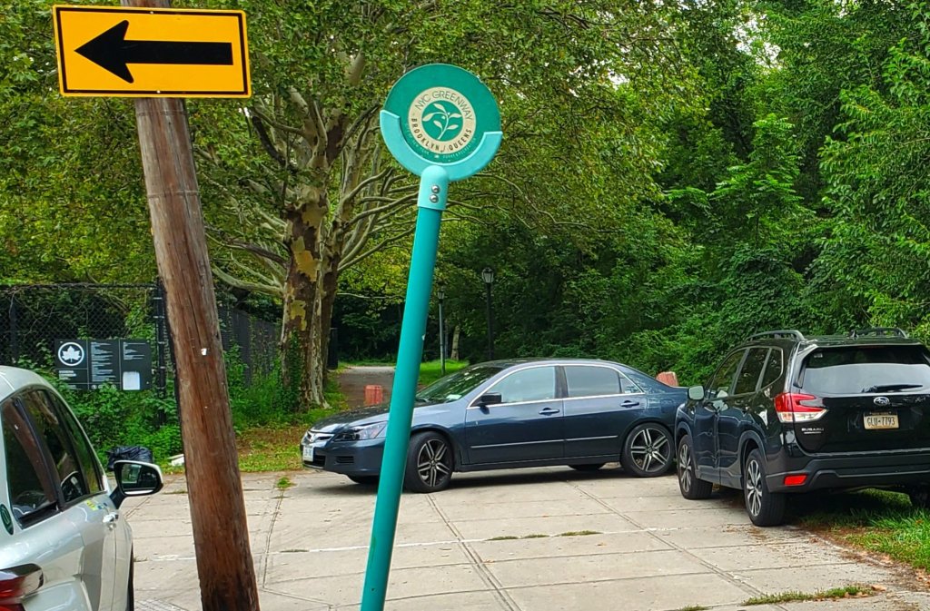 Two cars blocking the greenway since their owners (playing soccer) didn't feel like using the available legal parking spaces a few dozen feet away. 